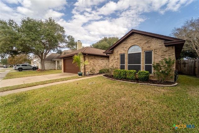 206 Ashland Crk, Victoria, TX 77901 - ranch-style home featuring brick siding, concrete driveway, a chimney, and a garage