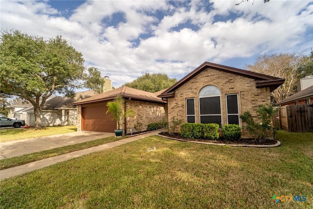 206 Ashland Crk, Victoria, TX 77901 - single story home featuring brick siding, concrete driveway, a chimney, and an attached garage