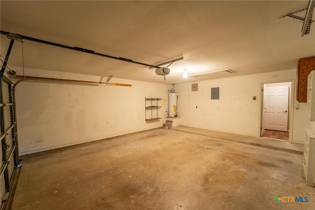 206 Ashland Crk, Victoria, TX 77901 - garage with gas water heater, a garage door opener, and electric panel