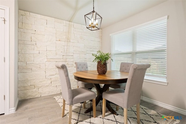 1306 Campbelton Dr, Temple, TX 76504 - dining room with baseboards, vaulted ceiling, light wood finished floors, and a notable chandelier