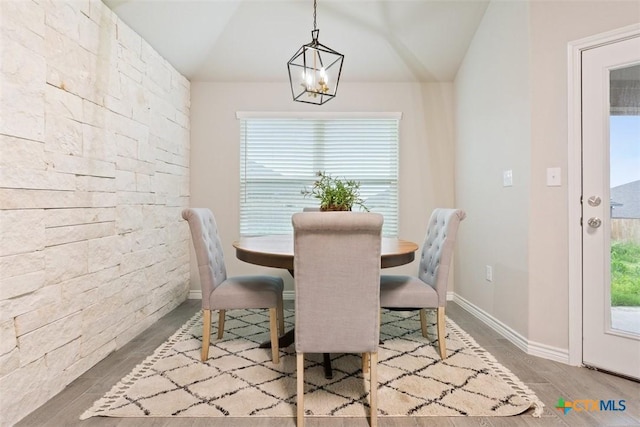 1306 Campbelton Dr, Temple, TX 76504 - dining area with baseboards, vaulted ceiling, wood finished floors, and a notable chandelier