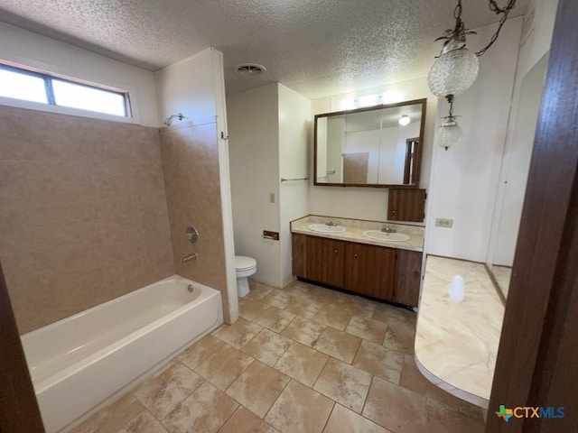 bathroom featuring shower / washtub combination, visible vents, toilet, a textured ceiling, and vanity