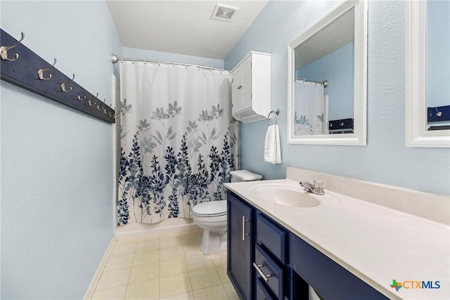bathroom with tile patterned floors, toilet, vanity, baseboards, and visible vents