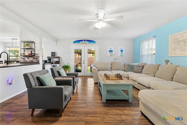 living area featuring dark wood-style floors, ceiling fan, french doors, and a healthy amount of sunlight