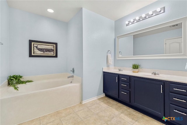 bathroom featuring double vanity, a bath, a sink, baseboards, and visible vents