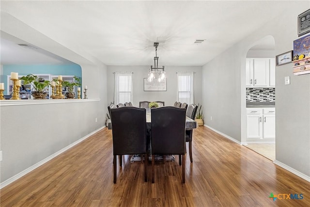 dining space with visible vents, baseboards, and light wood-style floors