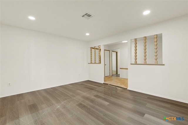 spare room featuring recessed lighting, visible vents, baseboards, and wood finished floors