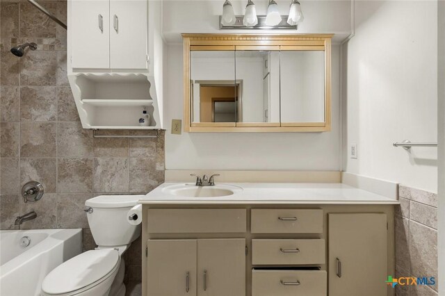 bathroom with toilet, shower / bath combination, tile walls, and vanity