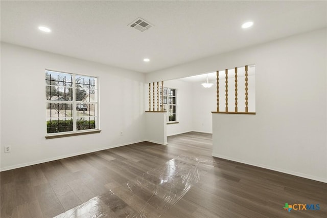 spare room featuring recessed lighting, visible vents, baseboards, and wood finished floors