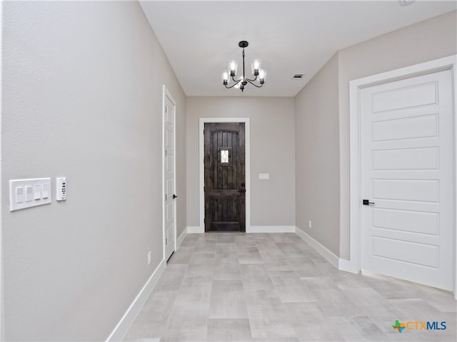 entryway featuring a chandelier