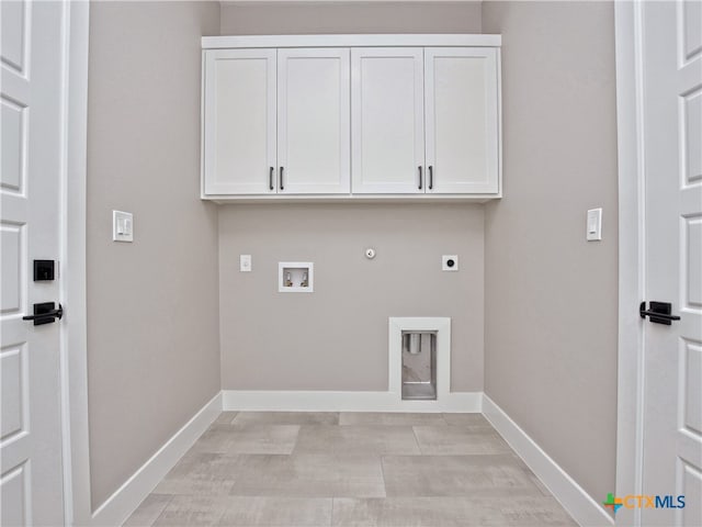 laundry area with hookup for a washing machine, electric dryer hookup, cabinets, and hookup for a gas dryer