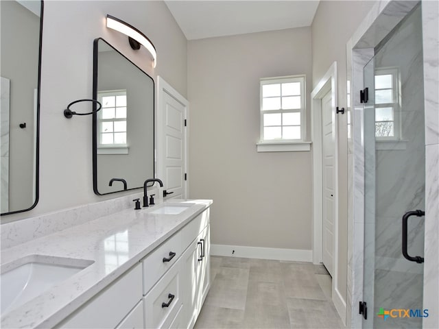 bathroom with plenty of natural light, vanity, and a shower with shower door