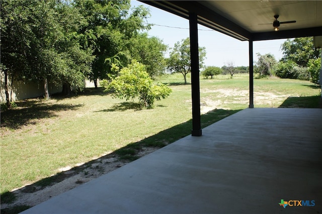 view of yard with ceiling fan and a patio