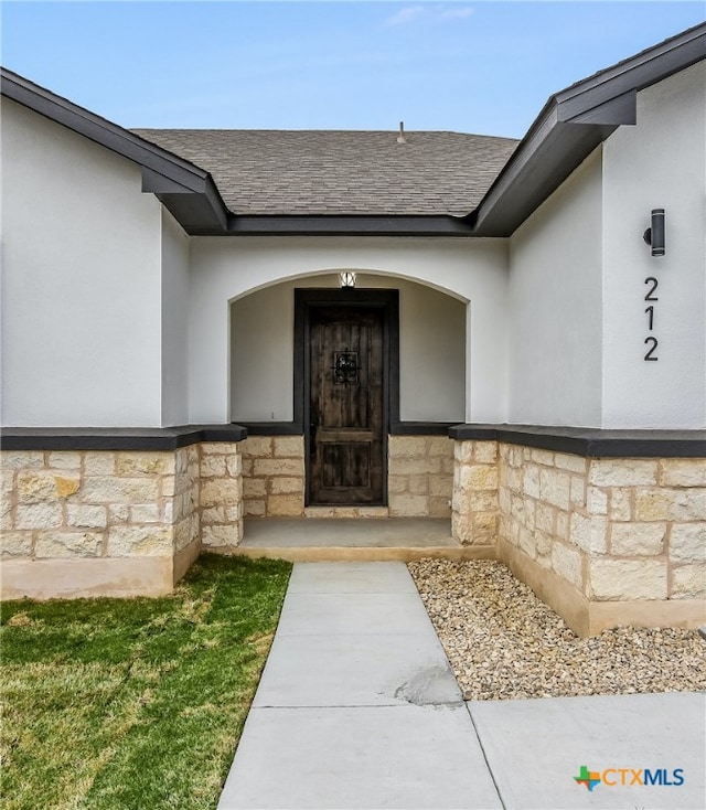 view of exterior entry featuring a yard