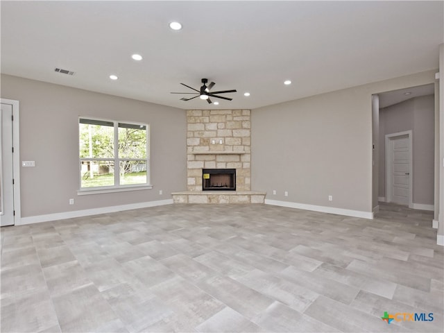 unfurnished living room featuring ceiling fan and a fireplace