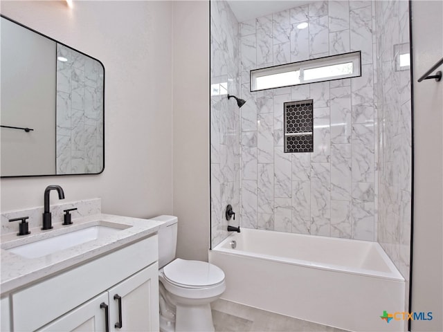 full bathroom featuring toilet, tiled shower / bath combo, vanity, and tile patterned flooring