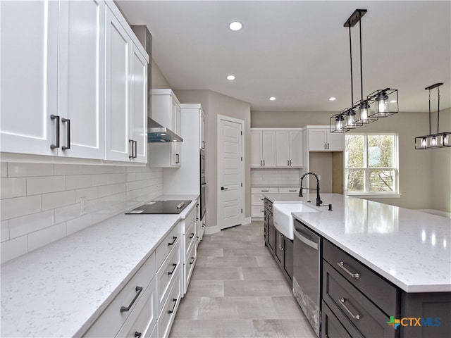 kitchen featuring a center island with sink, white cabinetry, pendant lighting, sink, and stainless steel dishwasher