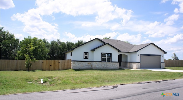 view of front of home with a garage and a front yard