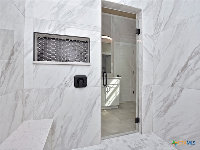 bathroom with a shower and tile walls