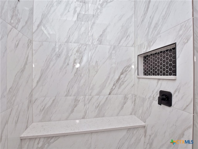 bathroom with tiled shower