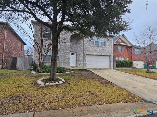 view of property featuring a garage and a front lawn