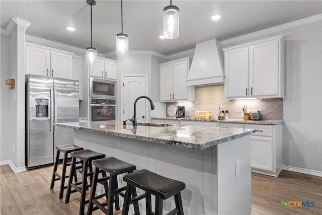 730 Eagle Pass Dr, Salado, TX 76571 - kitchen featuring white cabinetry, built in microwave, wall oven, stainless steel fridge, and custom range hood