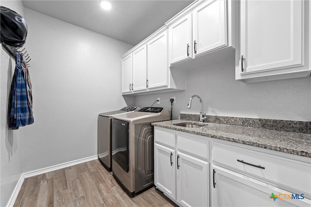 730 Eagle Pass Dr, Salado, TX 76571 - laundry room featuring sink, cabinets, washing machine and dryer, and light wood-type flooring
