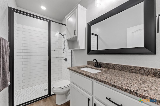730 Eagle Pass Dr, Salado, TX 76571 - bathroom featuring a shower with door, toilet, vanity, and wood-type flooring