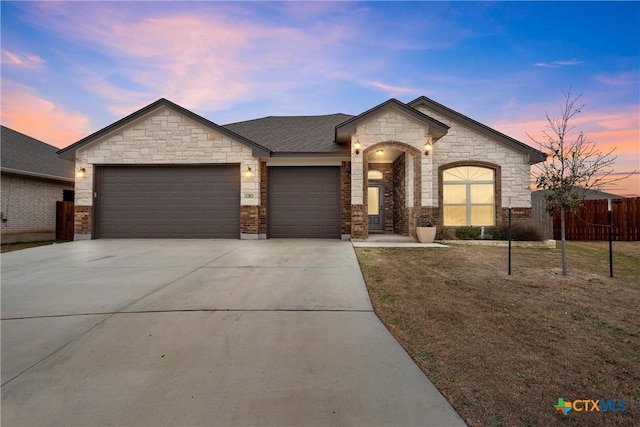 view of front of home with a garage and a yard