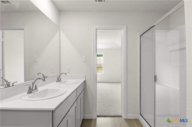 3812 Poteet Ct, Temple, TX 76504 - bathroom with wood finished floors, double vanity, and a stall shower