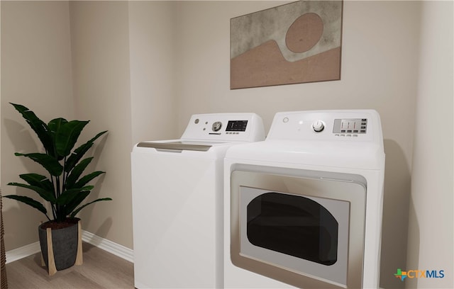 3812 Poteet Ct, Temple, TX 76504 - laundry area featuring baseboards, wood finished floors, washer and clothes dryer, and laundry area