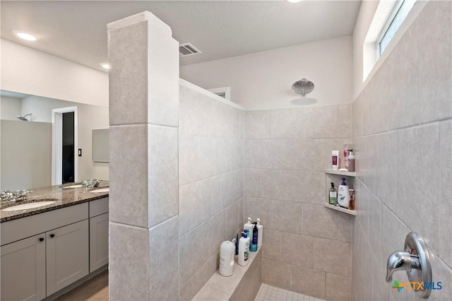 full bath with walk in shower, visible vents, and vanity