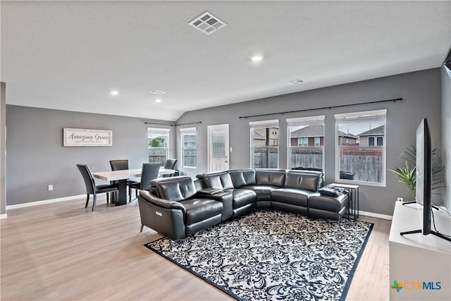 living room with baseboards, visible vents, wood finished floors, and recessed lighting