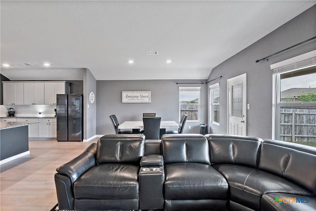 living room with baseboards, visible vents, light wood-style floors, and recessed lighting