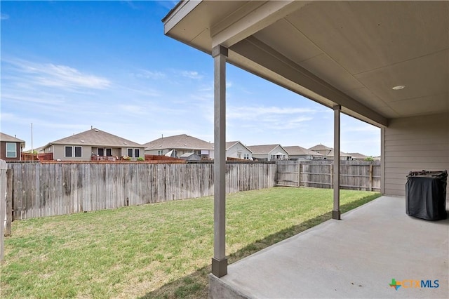 view of yard featuring a fenced backyard, a residential view, and a patio area