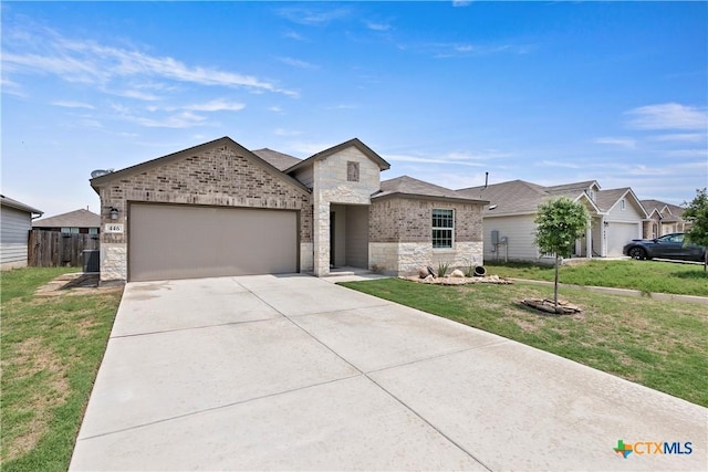 single story home with a front yard, driveway, stone siding, an attached garage, and fence