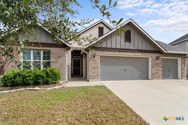 view of front of property featuring a garage and a front yard