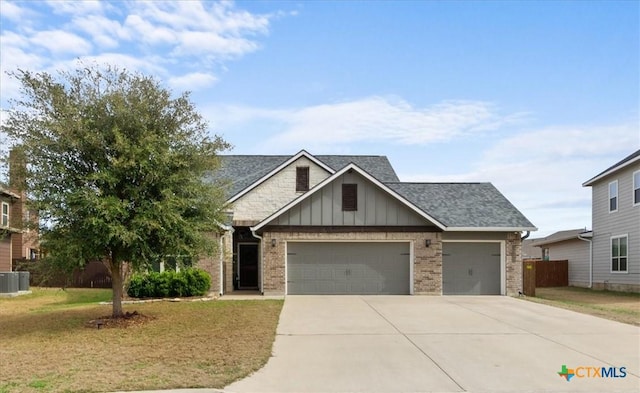 view of front of house with a garage, a front yard, and cooling unit