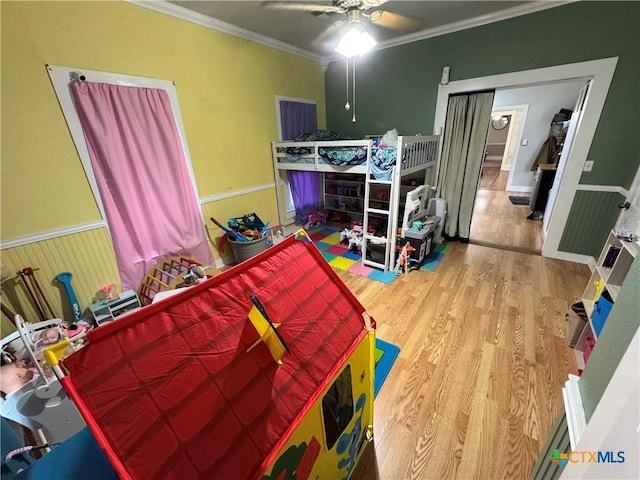 bedroom featuring crown molding, ceiling fan, and wood-type flooring