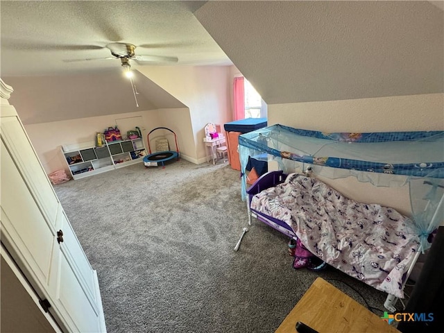 bedroom featuring lofted ceiling, a textured ceiling, carpet floors, and ceiling fan