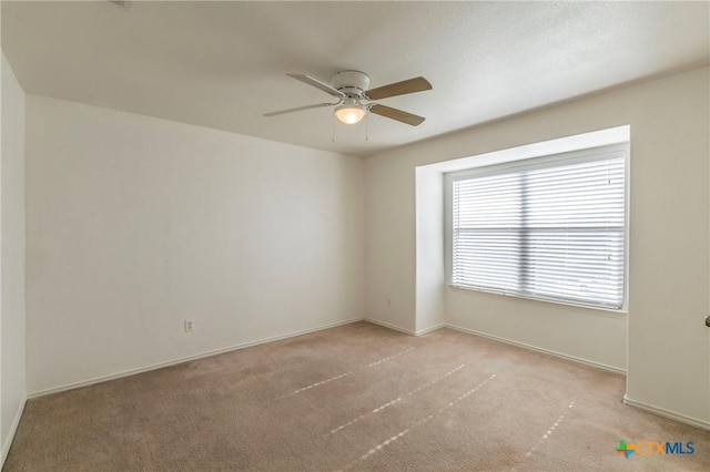 empty room with light carpet and ceiling fan