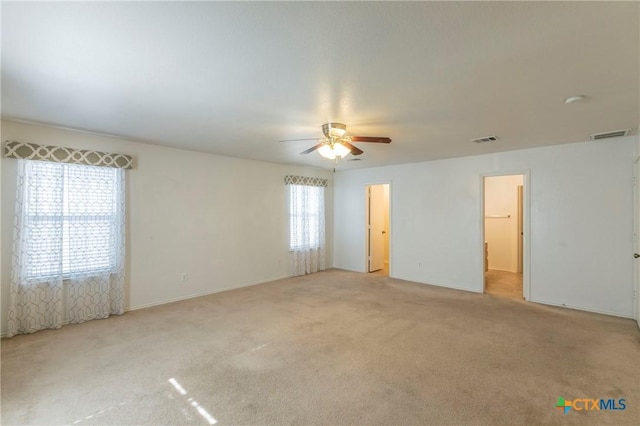 carpeted empty room featuring ceiling fan