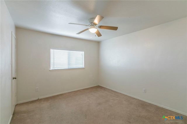 spare room with light colored carpet and ceiling fan