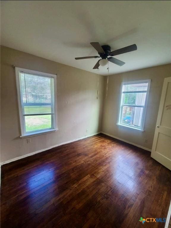 empty room featuring baseboards, ceiling fan, and wood finished floors