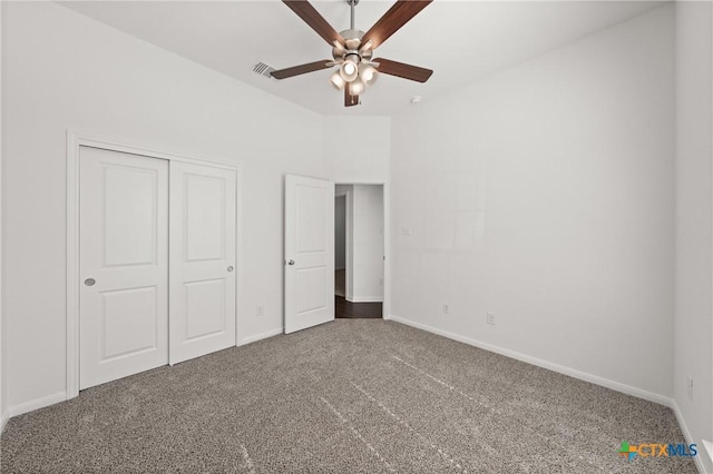 unfurnished bedroom with visible vents, baseboards, ceiling fan, carpet floors, and a closet