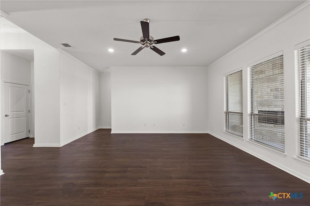 empty room with dark wood-style floors, ornamental molding, and visible vents