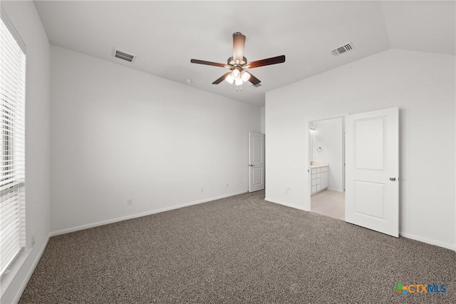 unfurnished bedroom with vaulted ceiling, baseboards, visible vents, and light colored carpet