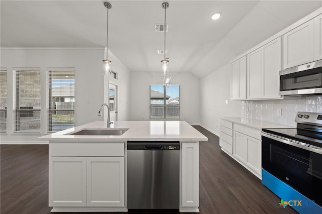 kitchen with tasteful backsplash, appliances with stainless steel finishes, dark wood-type flooring, light countertops, and a sink