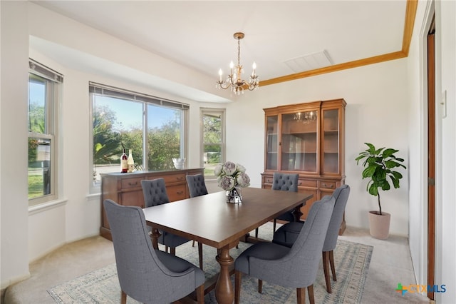 dining area with ornamental molding, light colored carpet, and a notable chandelier