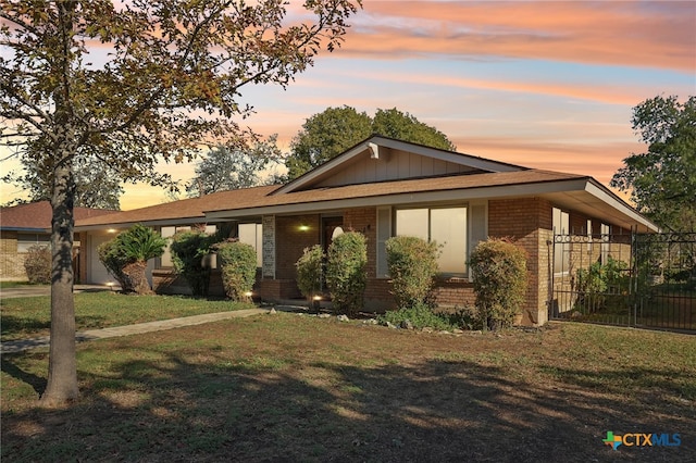 ranch-style house featuring a yard